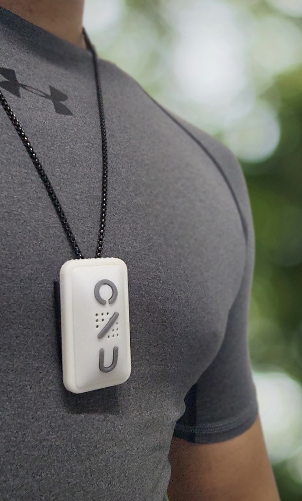 The ONU device worn on a lanyard around the neck, outdoors